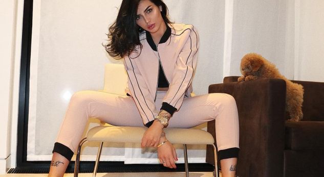 Morena fotografohet nga pas, e ulur në tavolinë për pozën e zjarrtë